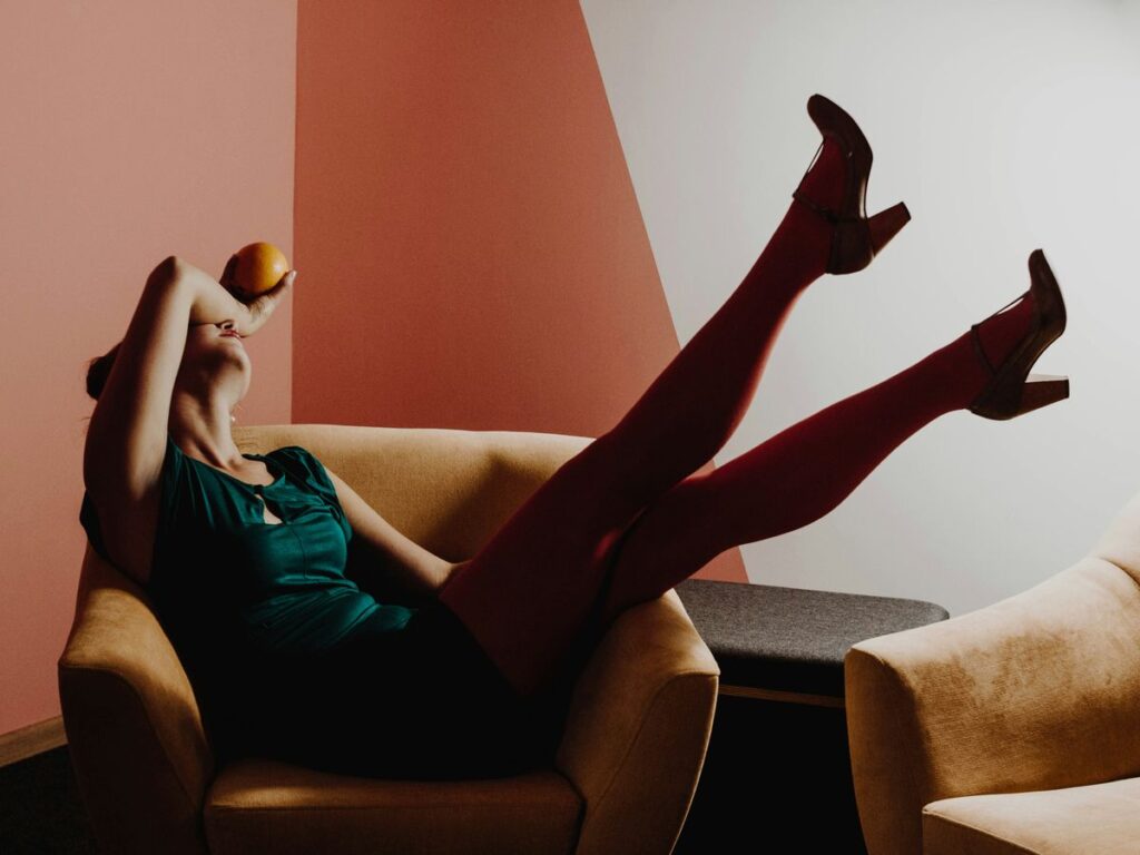 woman sitting on brown armchair