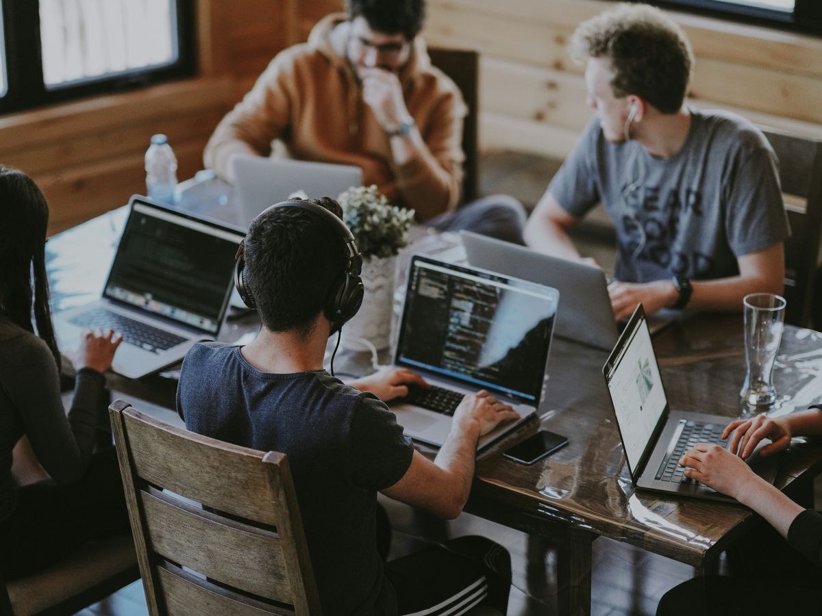 group of people using laptop computer