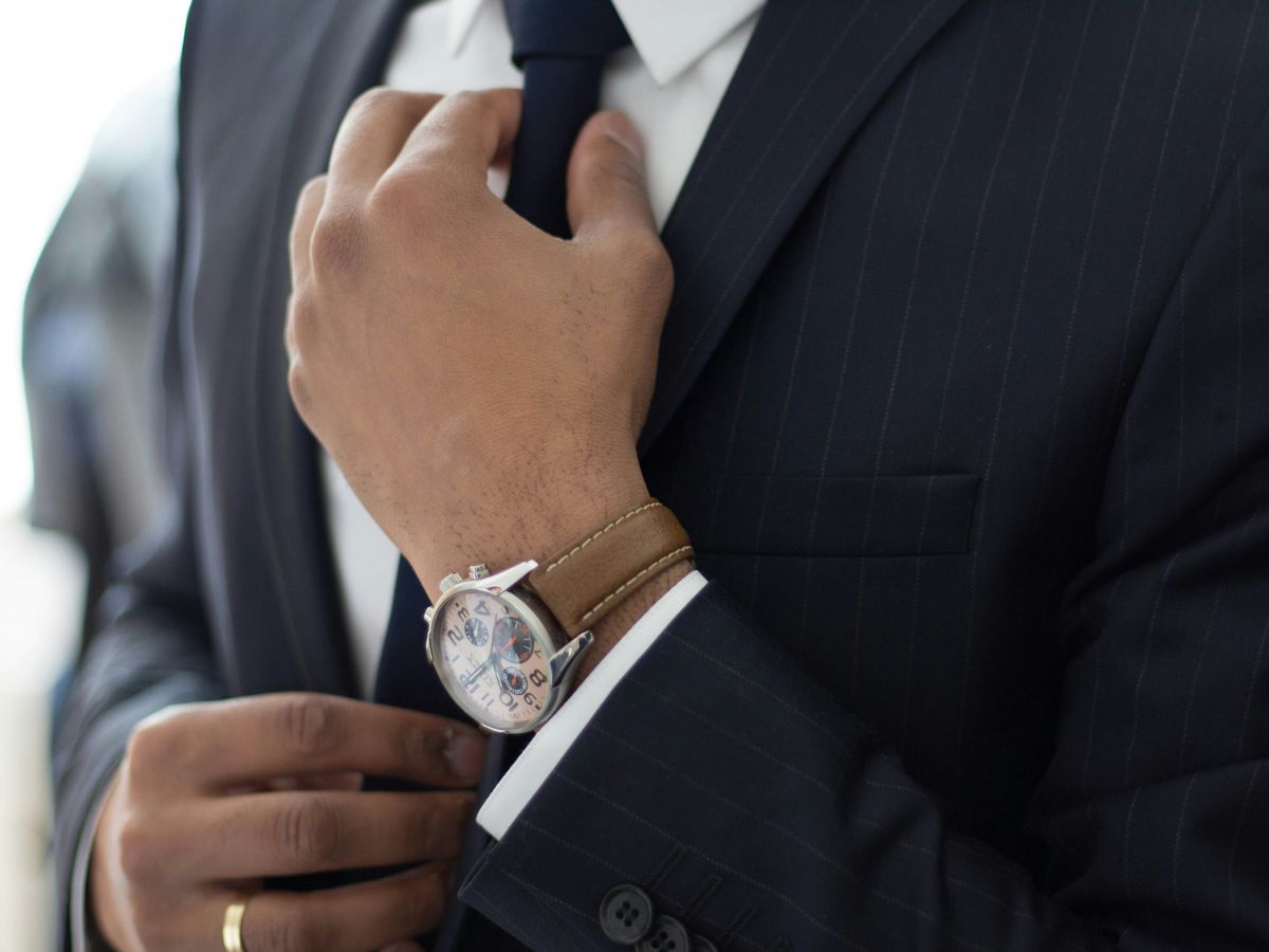 man wearing watch with black suit