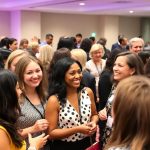 Femei diverse discutând la un eveniment de networking.