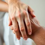 Mână feminină și masculină care se țin